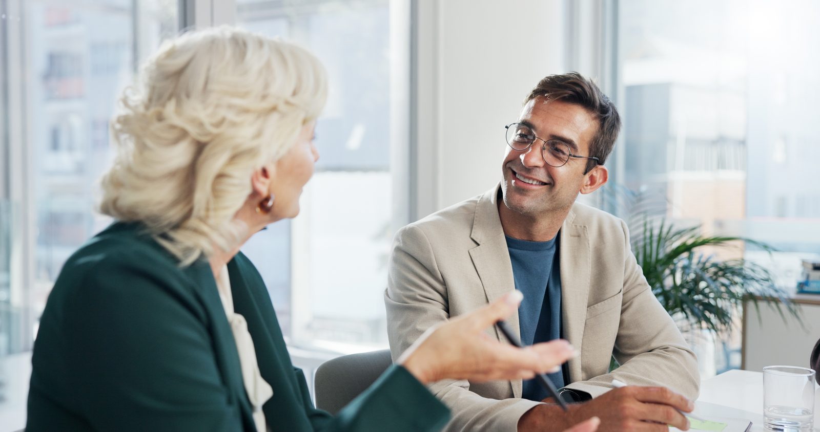 An advisor and client talking across a desk
