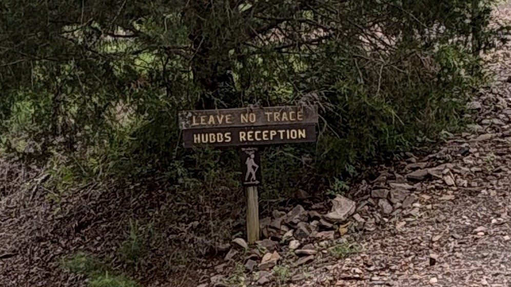 Leave No Trace? — a wooden trail sign reading Leave No Trace, Hubbs Reception on a wooded camp path